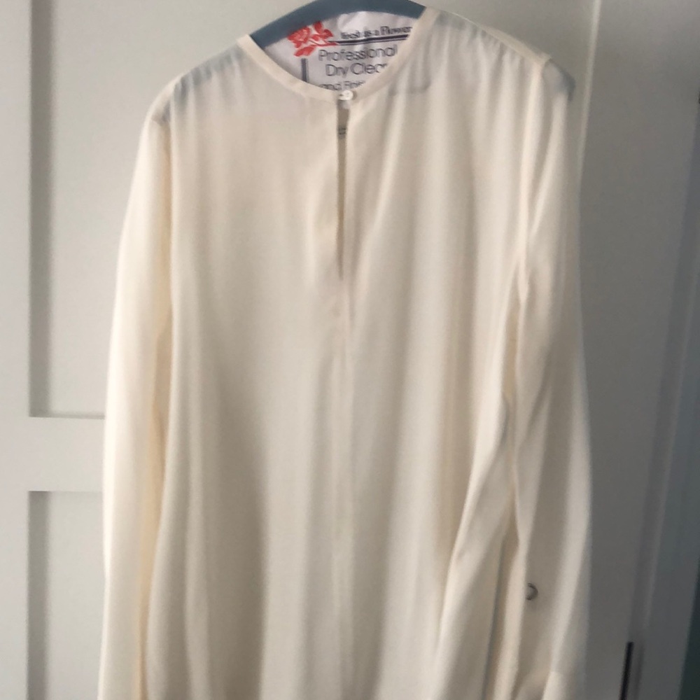 Cream blouse with ties at bottom of sleeves